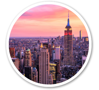 A circular image of a cityscape at sunset, featuring the Empire State Building prominently lit against a vibrant pink and orange sky, evoking a serene urban atmosphere.